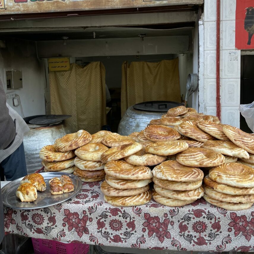 A photograph of freshly baked bread and pastries outside an Uzbek bakery.
